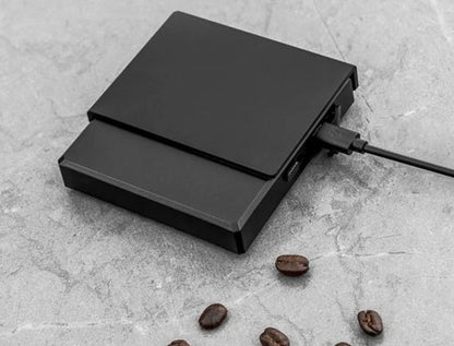 0.1g High Precision Drip Espresso Scale being charged with Type-C cable connected on the side, showing fast and convenient charging.


